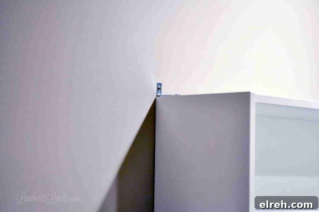 Turn IKEA Billy Bookcases into Built-In Shelving 10 metal brace installed on top of cabinet.