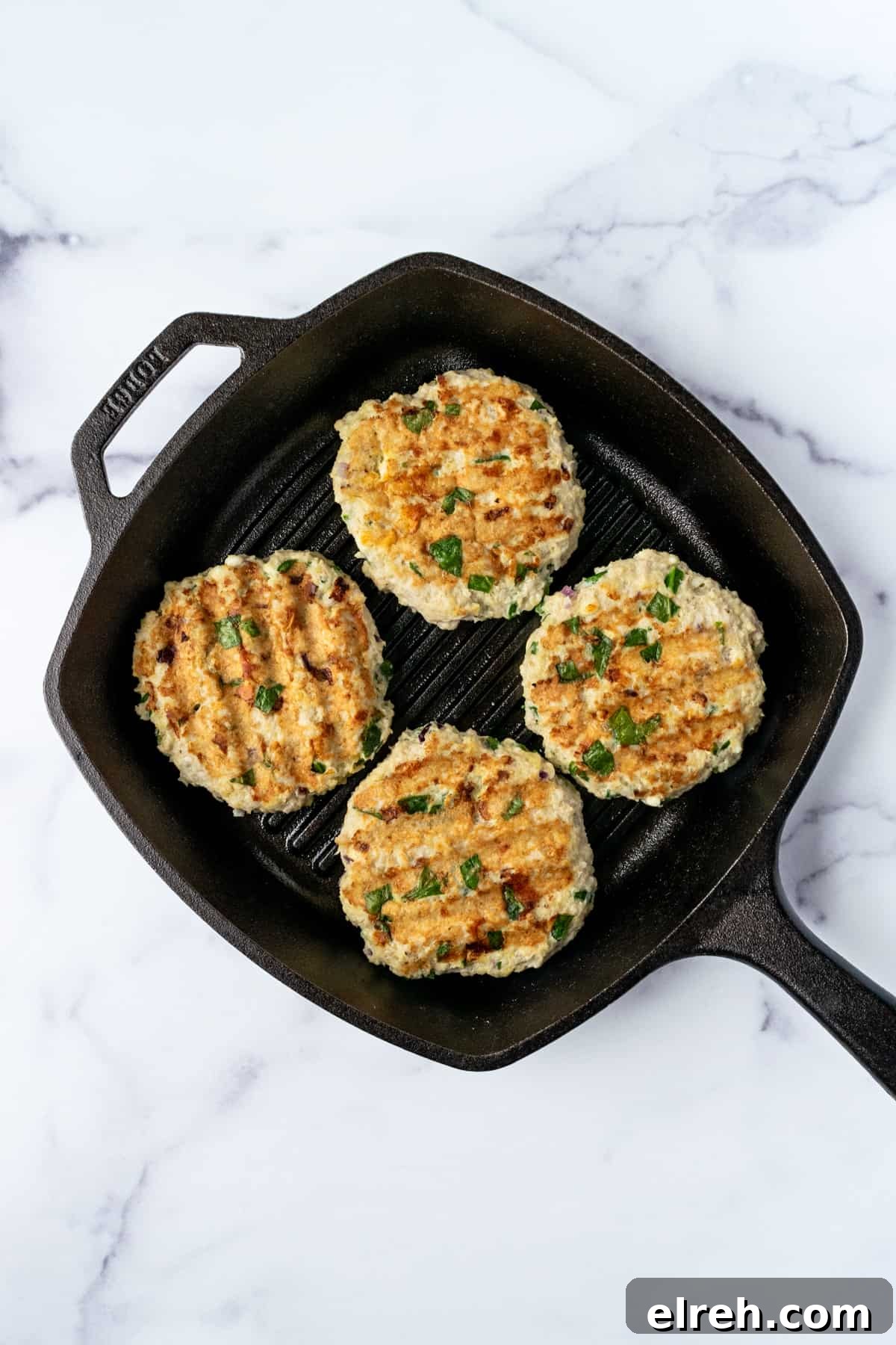Greek Spinach Feta Chicken Burgers 7 Juicy Spinach and Feta Chicken Burgers in a Grill Pan.