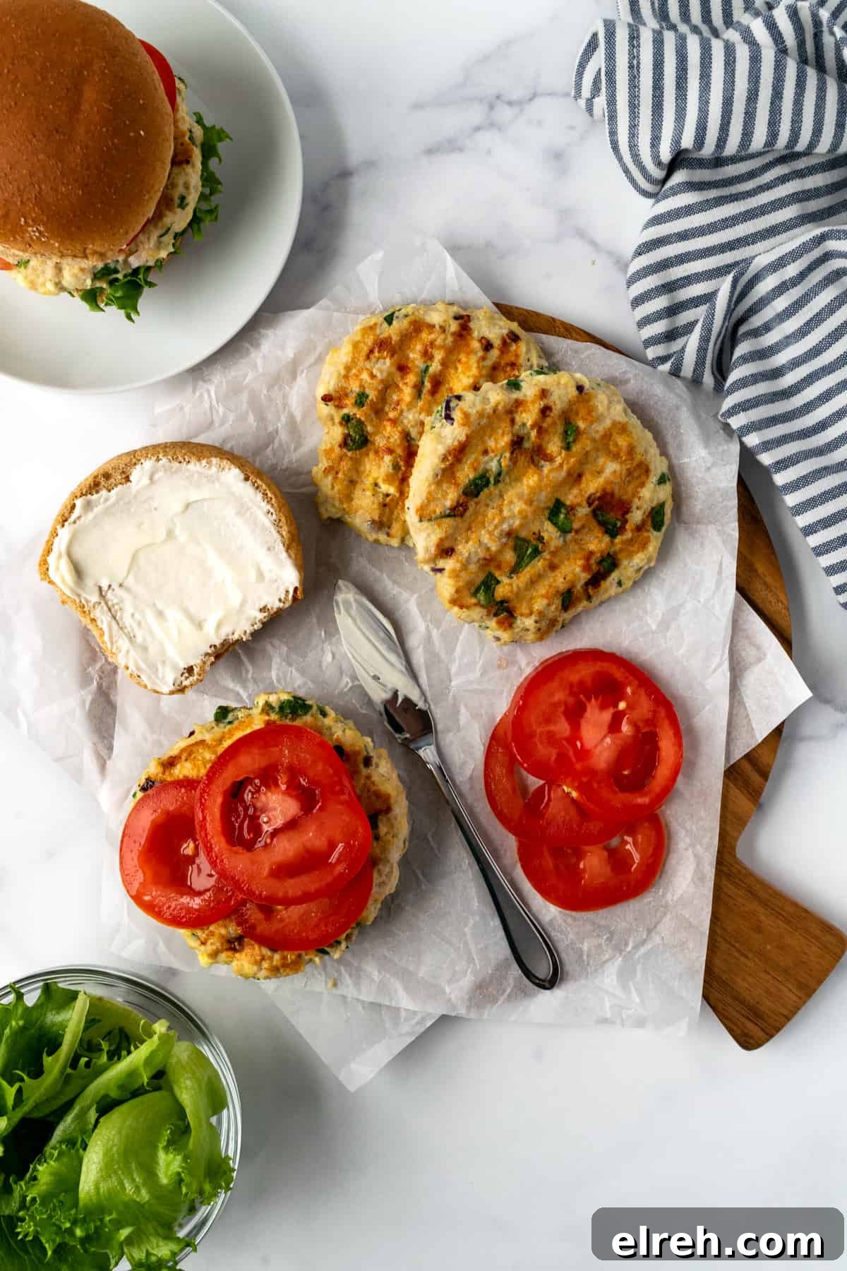Greek Spinach Feta Chicken Burgers 8 Spinach Feta Chicken Burgers on a serving board.