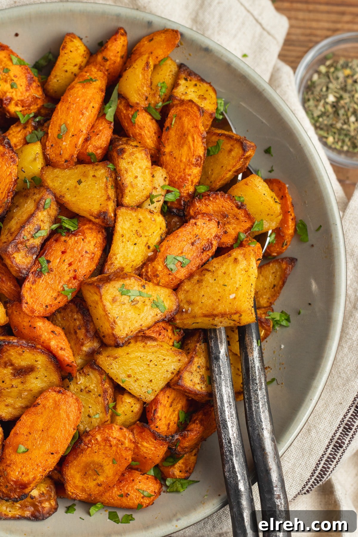 Air fried carrots and potatoes served on a plate.