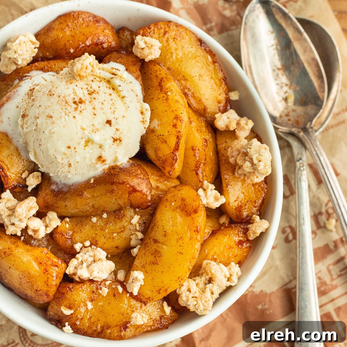 Cooked apples with ice cream and granola.