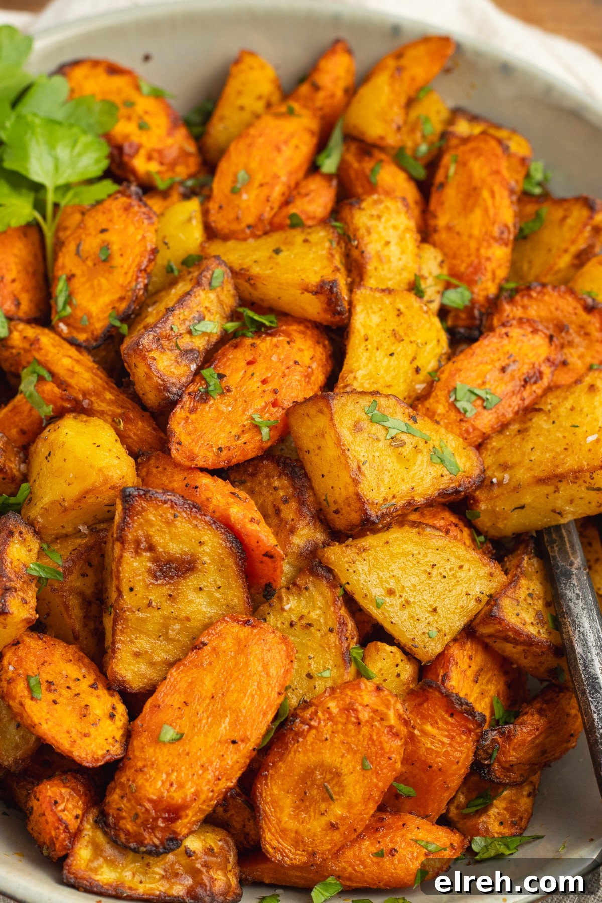 Air fryer potatoes and carrots served in a bowl.