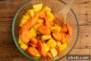 Seasoned carrots and potatoes in a bowl.