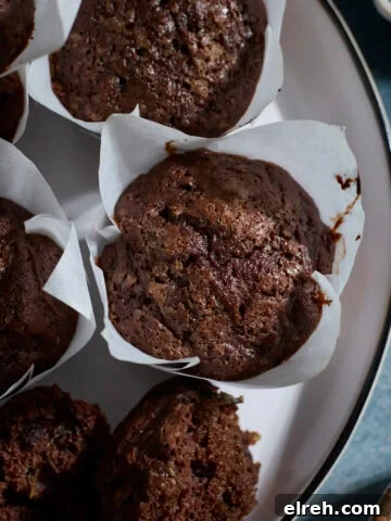 Chocolate Sourdough Zucchini Muffins on a white platter.