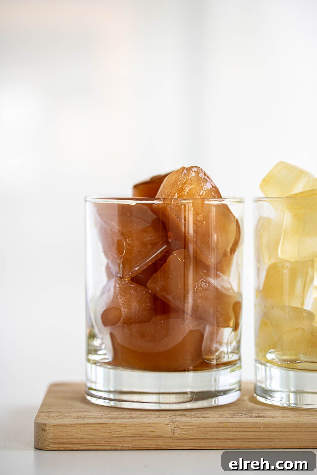 How to Make Tea Ice Cubes for Iced Tea, Lattes and Cocktails 2 Black and herbal tea ice cubes inside glass.