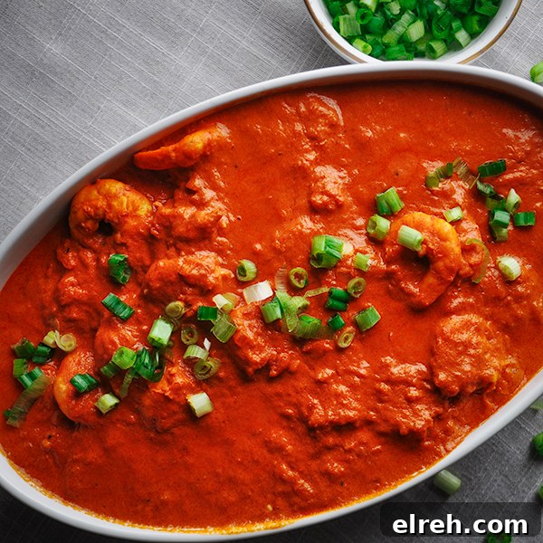 A serving bowl filled with Indian Shrimp and Rice.