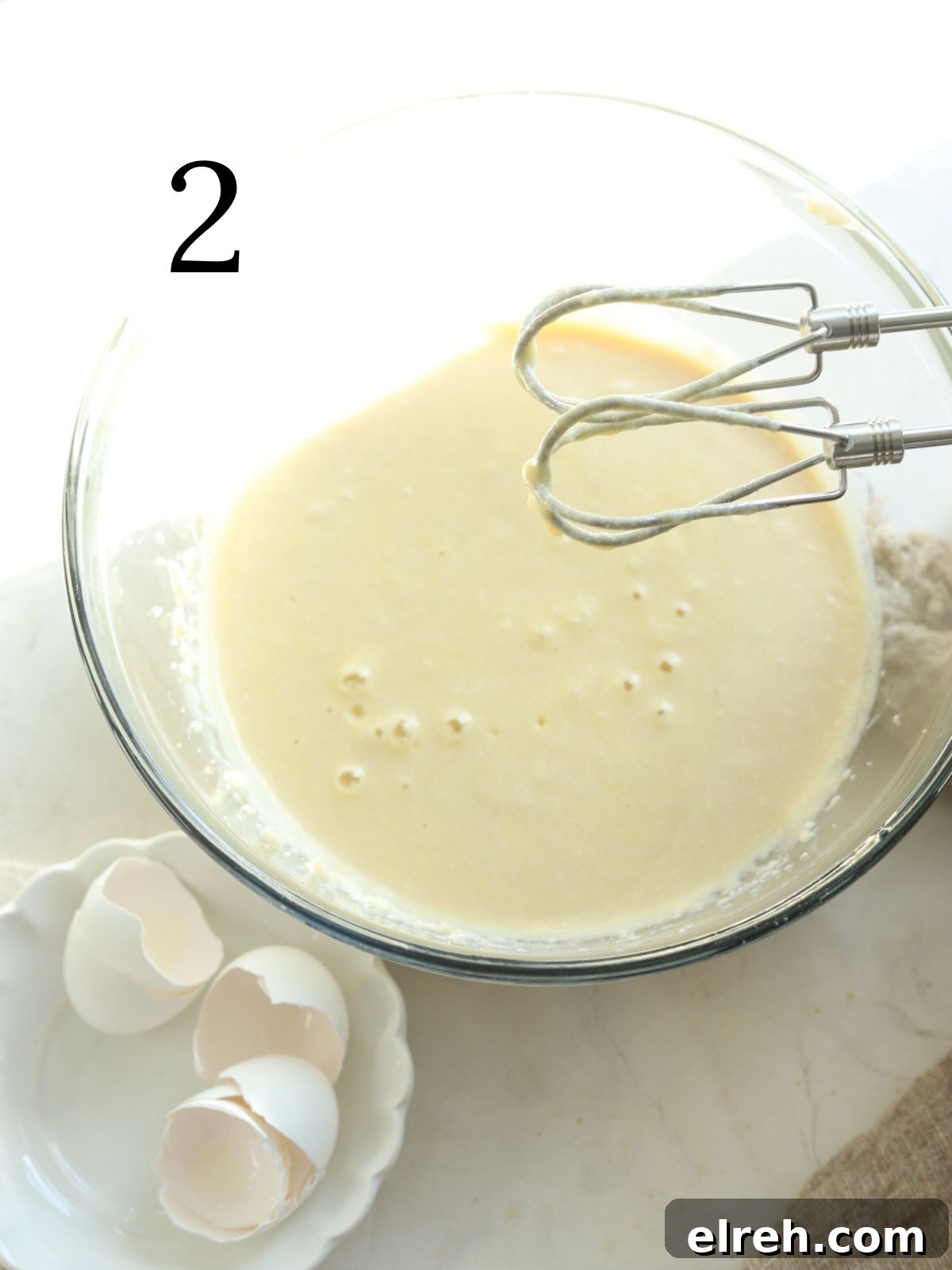 Mixing bowl with cake batter and an electric mixer