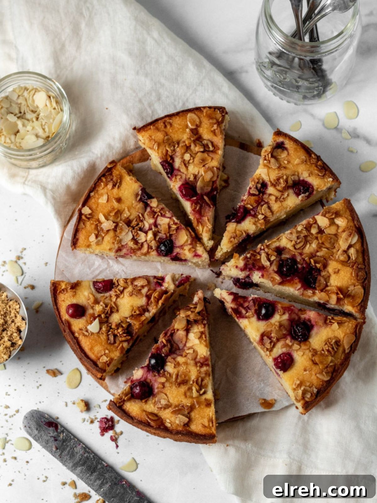 Sliced cranberry almond cake on a plate