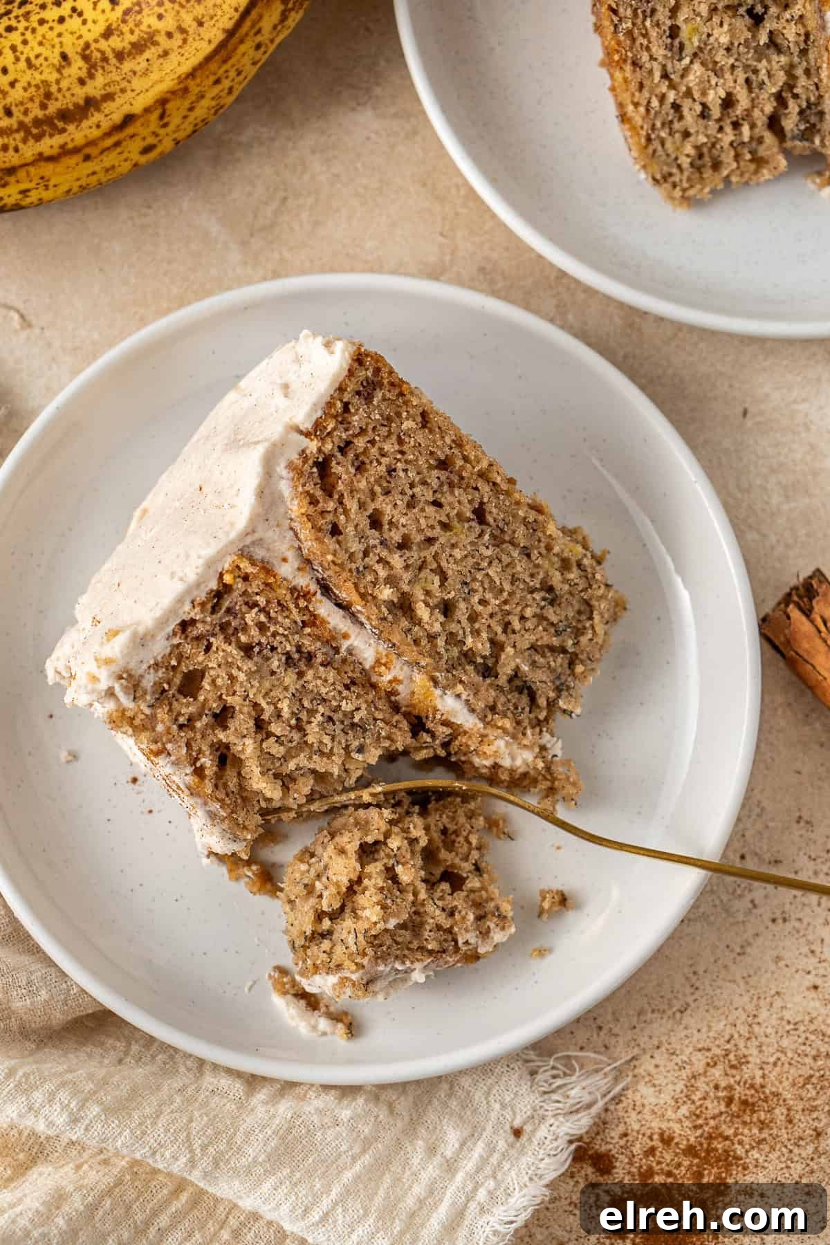 A slice of cake on a plate with a fork.