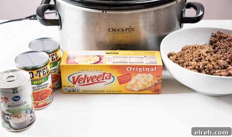 Slow Cooker Queso with Beef and Sausage 3 crock pot with velveeta, rotel, cream of mushroom soup, ground beef and ground sausage for slow cooker queso cheese dip