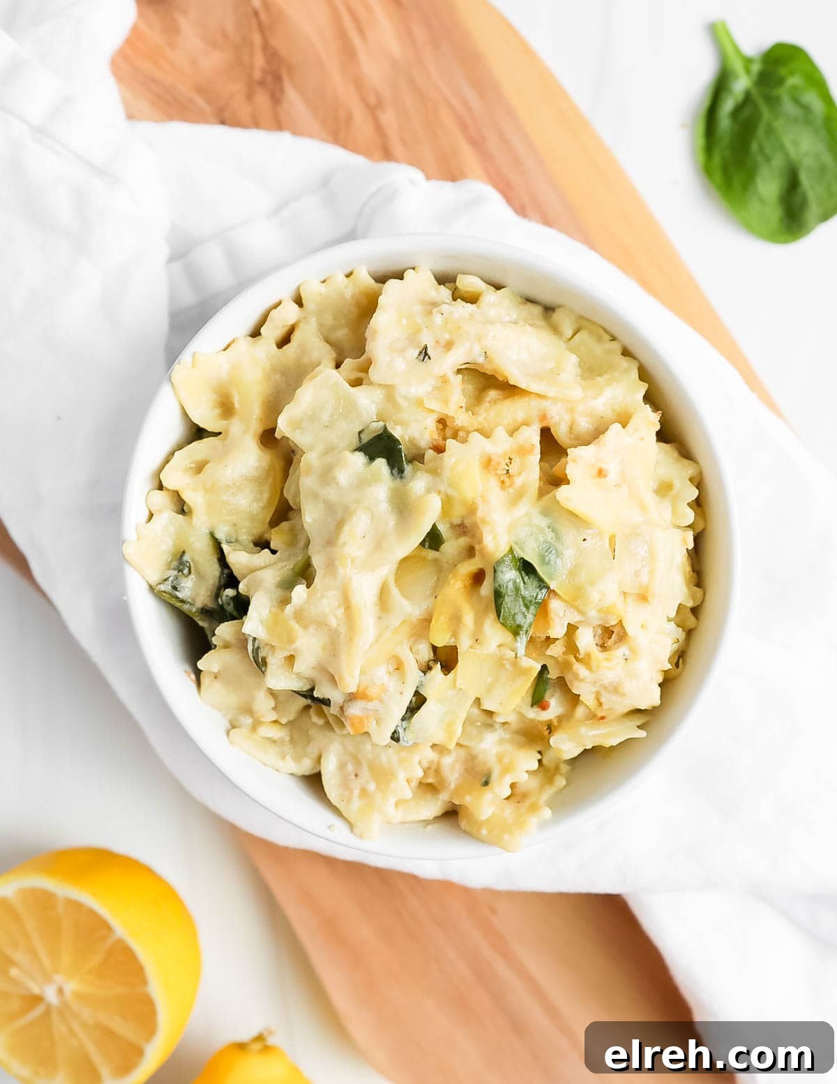 an overhead picture of pasta in white sauce in a white bowl.
