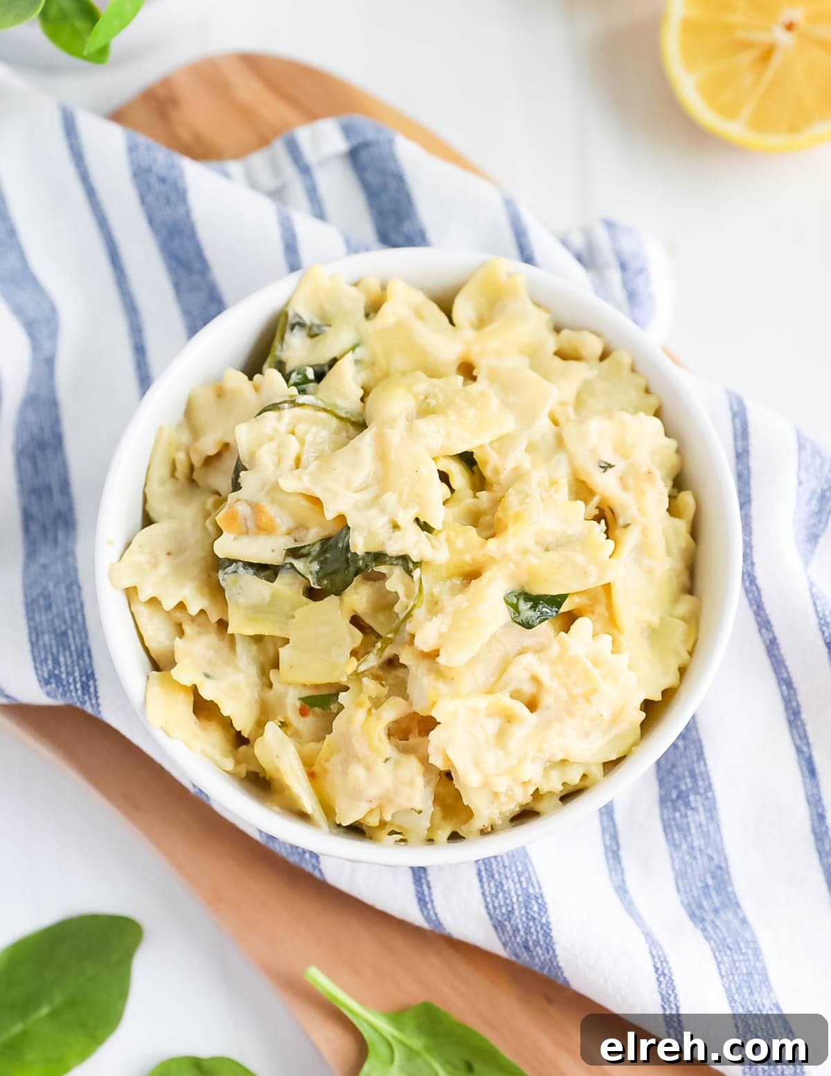 Creamy white pasta in a white bowl.