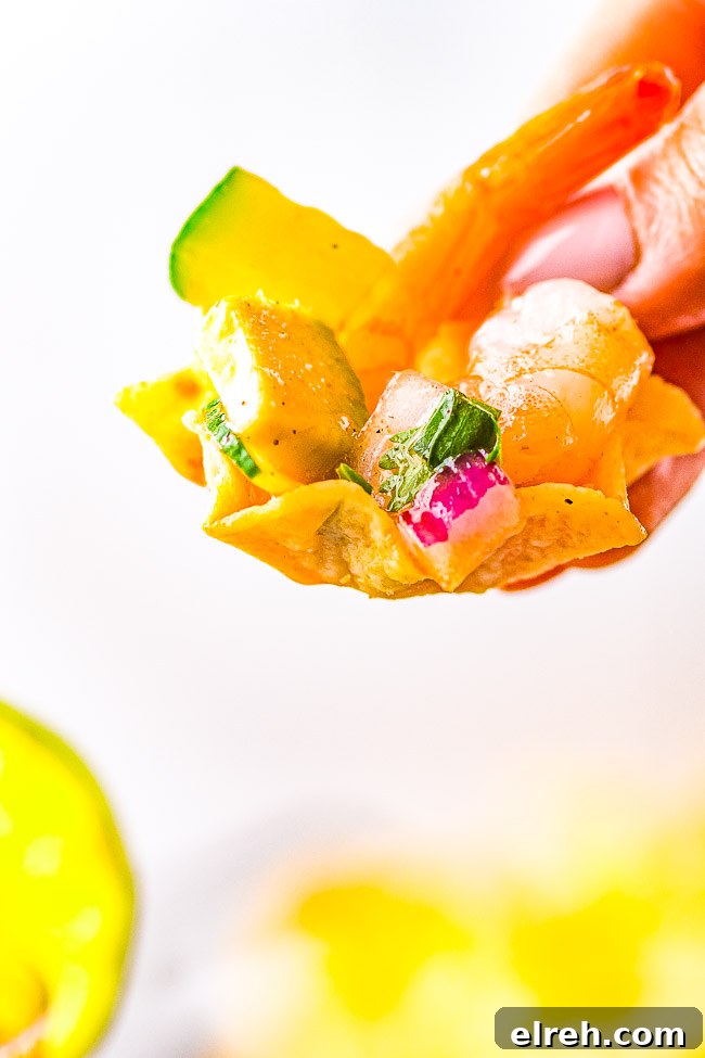 Authentic Mexican Shrimp Cocktail Recipe 11 A tortilla chip holding a scoop of Mexican shrimp cocktail.