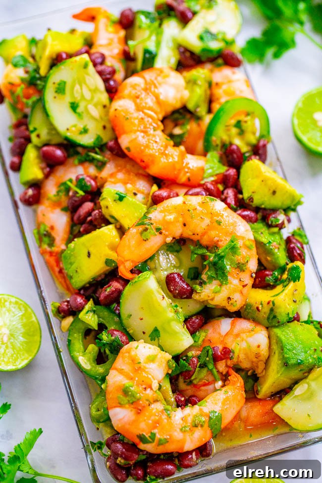 Authentic Mexican Shrimp Cocktail Recipe 19 Lime Cilantro Shrimp and Black Bean Salad on a plate.