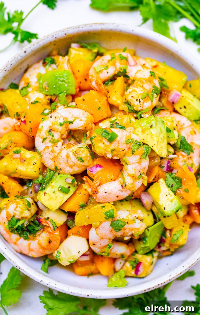 Authentic Mexican Shrimp Cocktail Recipe 22 A bowl of avocado mango shrimp salad.