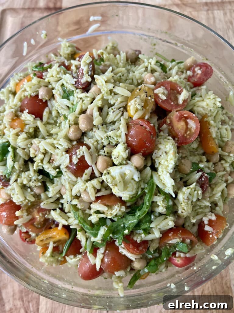 Finished mediterranean orzo pasta  salad caprese in glass bowl.
