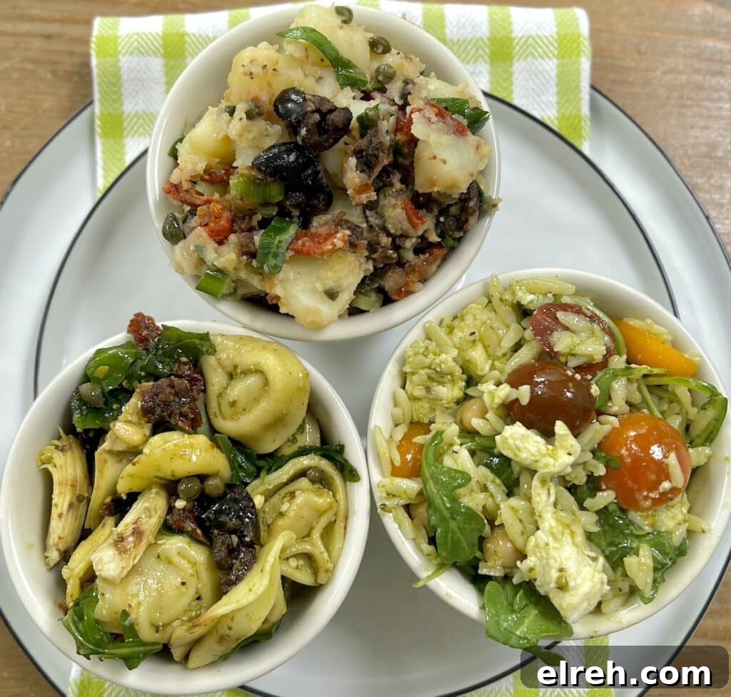 Trio of summer salads in small bowls on a white plate with green towel.