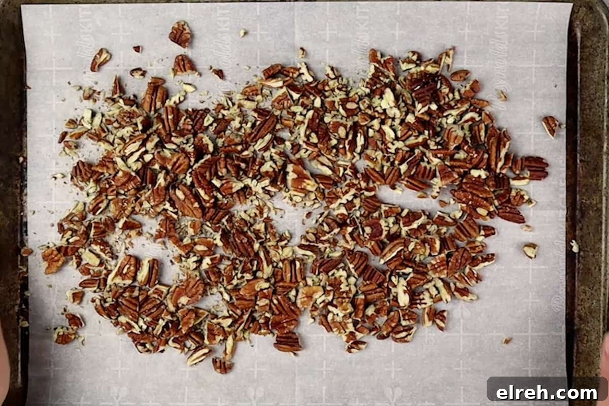 Old Fashioned Pecan Pie Recipe 6 toasted pecans on baking sheet.
