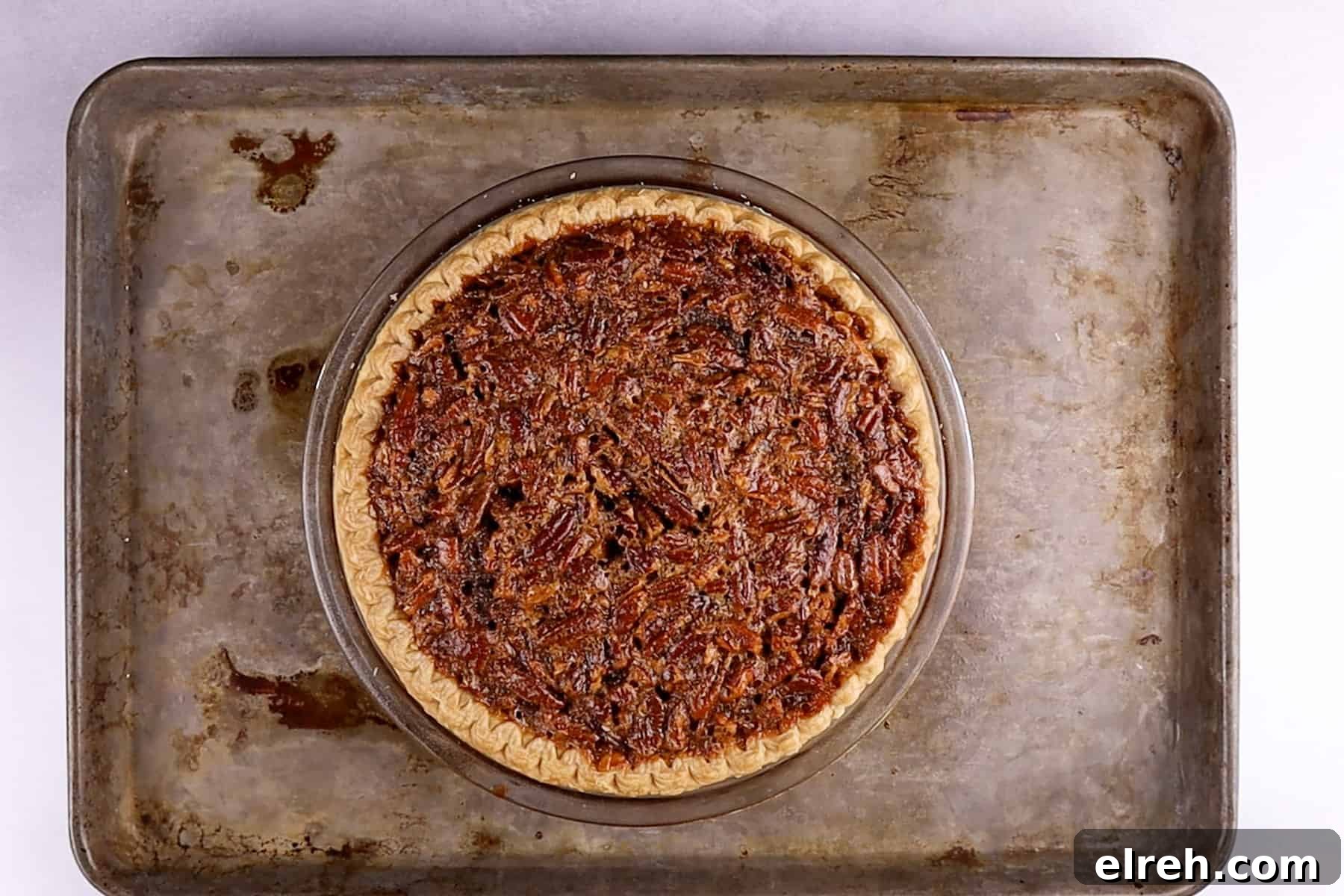 Old Fashioned Pecan Pie Recipe 9 baked pecan pie on a baking sheet.