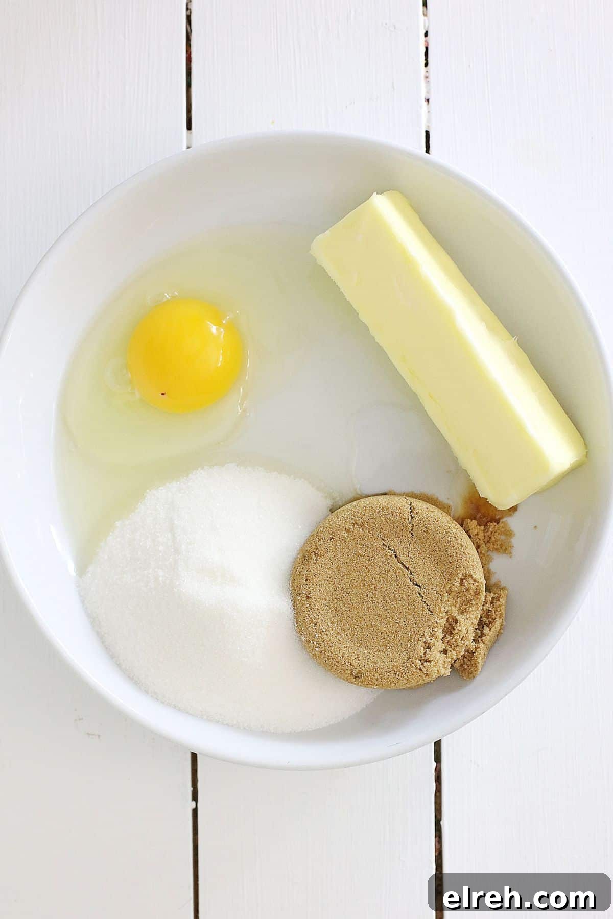 Muddy Buddy Cookies: Chocolate Peanut Butter Crunch 4 bowl filled with butter, sugar, brown sugar, and an egg.