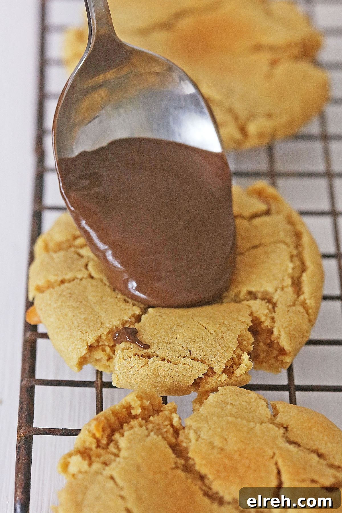 Muddy Buddy Cookies: Chocolate Peanut Butter Crunch 6 chocolate ganache being added to the top of peanut butter cookies.