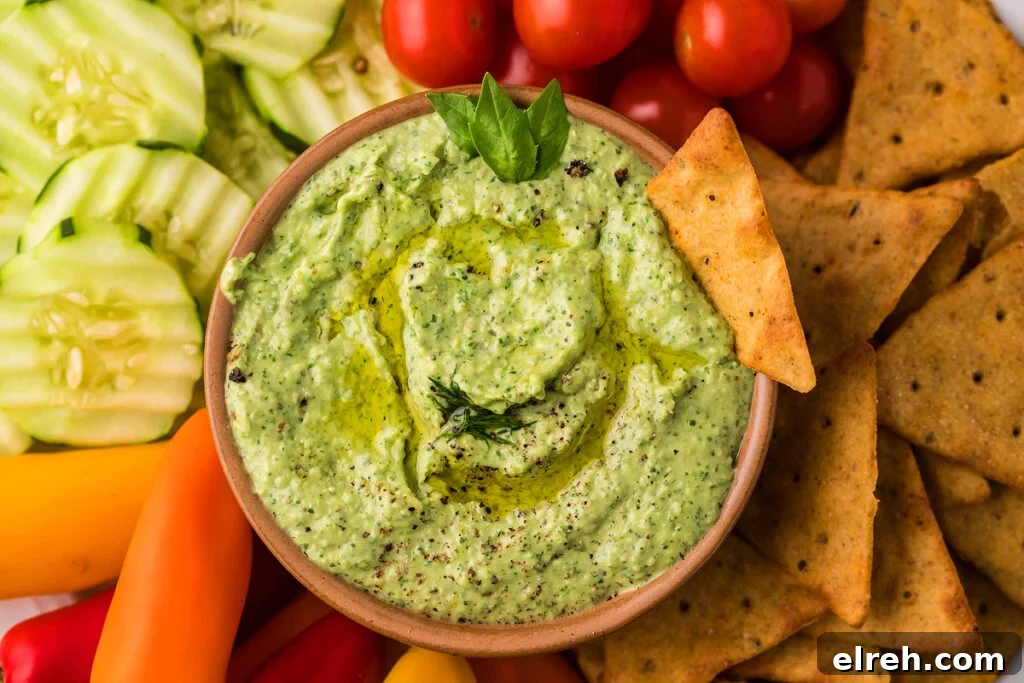 50 July Recipes to Cook This Summer 34 Side view of avocado herb green dip with vegetables on the side.