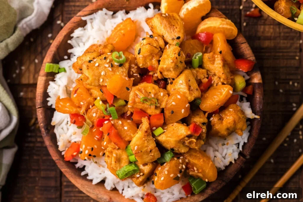 50 July Recipes to Cook This Summer 40 Tangerine chicken stir fry in a bowl with rice.
