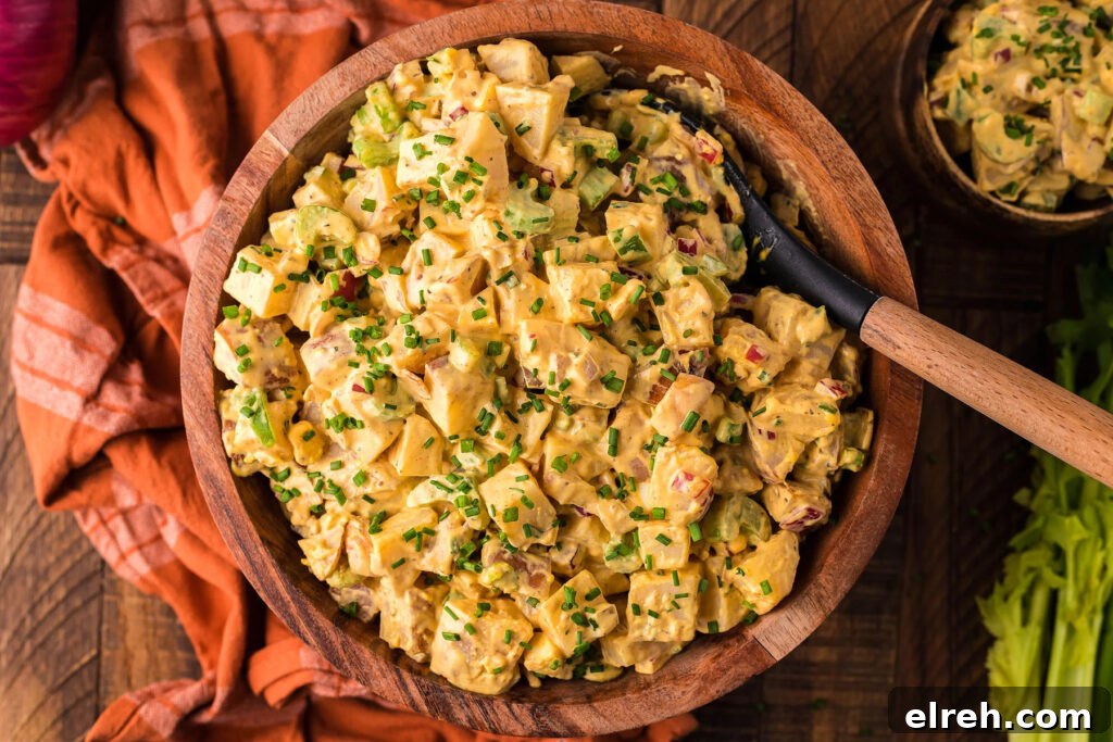 50 July Recipes to Cook This Summer 47 Potato salad in a wood bowl with a spoon.