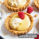 Mini Lemon Curd Tartlets with Buttery Crust 10 A lemon curd tartlet topped with raspberries and cream.