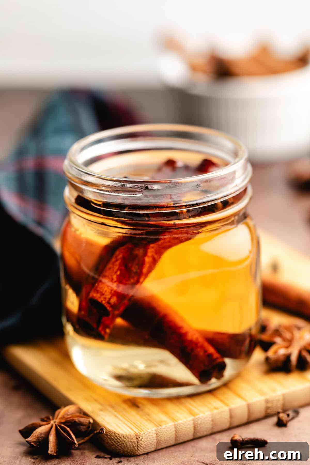 Close up view of spiced simple syrup in a jar.