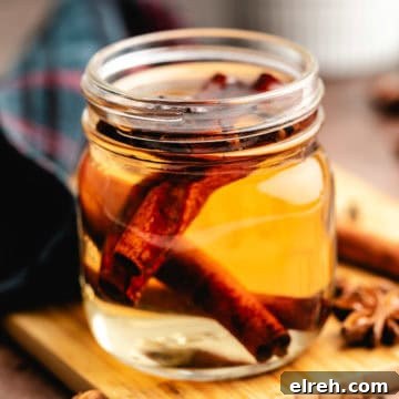 Small jar of spiced simple syrup with cinnamon.