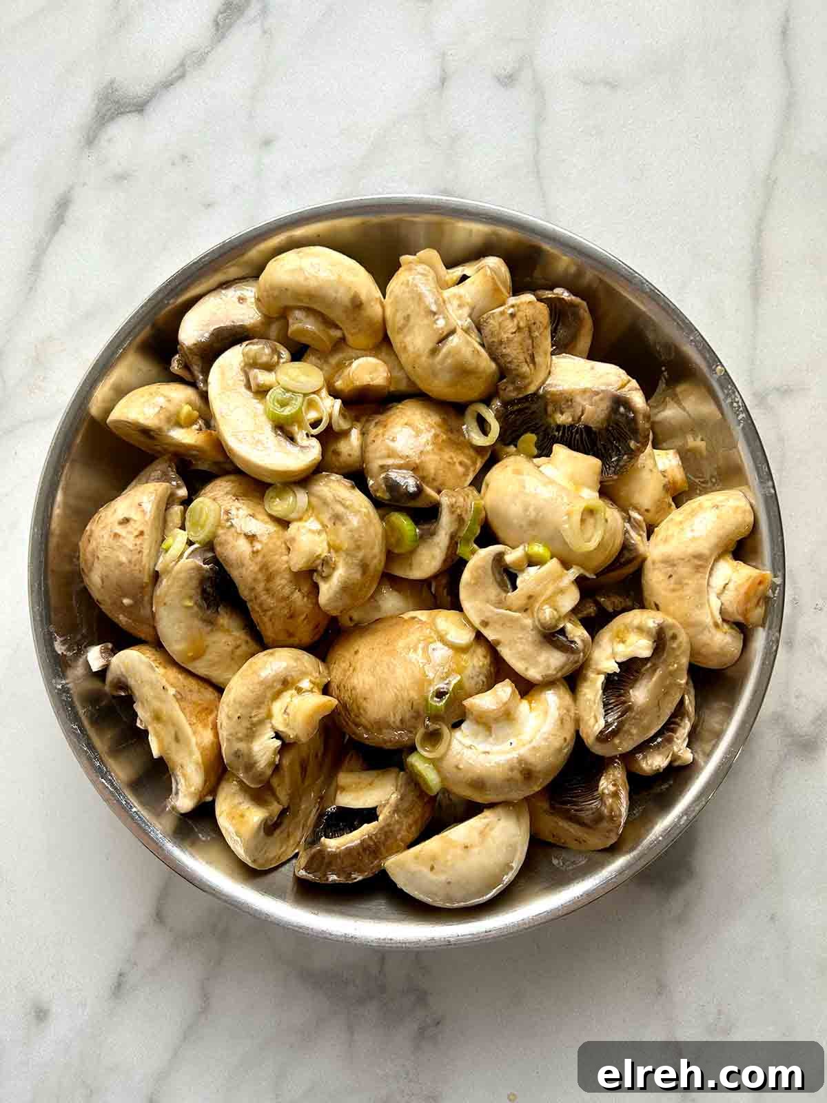 mushrooms mixed with seasonings in shallow dish
