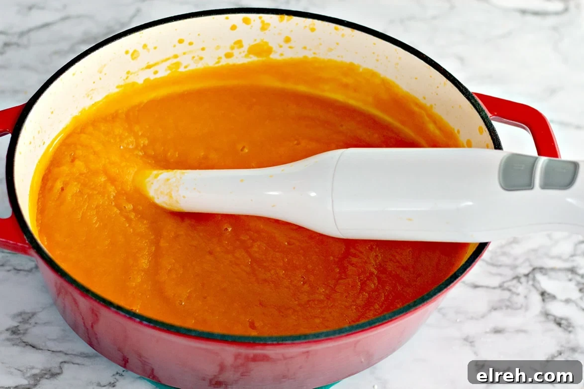 pureed soup in a dutch oven with an immersion blender 